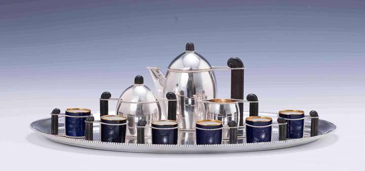 TEN PIECE SILVER MOCHA SERVICE
consisting of: mocha pot, creamer, sugar bowl, 6 cups, oval tray
